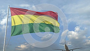 Airliner flying over waving flag of Bolivia. 3D rendering