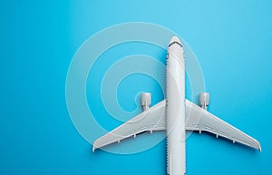 Airliner plane on a blue background and place for text. Traveling by plane. Booking tickets and accumulating air mile bonuses.