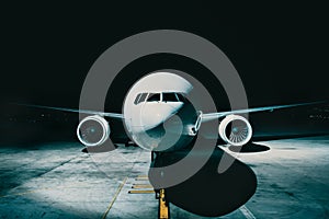 Airliner plane parked at the terminal view from the front cockpit fuselage, on runway at night