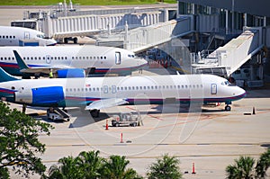 Airliners planes connected to terminal gate at airport