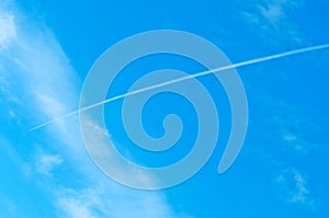 Airoplane on a cloudy blue sky