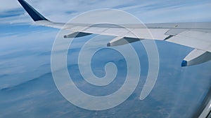 An airoplane wing and blue sky