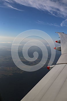 Airplane above the cloud on the sky background