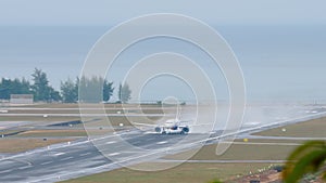 Airplane accelerating at wet runway