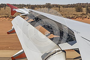 Airplane activates ground spoilers as it lands at Ayers Rock airport, Australia