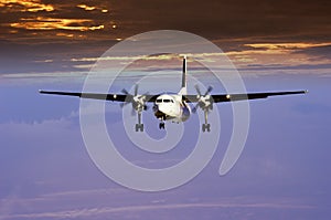 Airplane against sunset