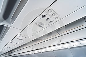 Airplane air conditioning control panel over seats, Stuffy air in aircraft cabin with people, New low-cost airline