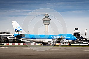 Airplane with air traffic control tower. Boeing 747 landing at an airport. Jumbo jet with reverse thrust