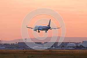 Airplane airport landing in a sundown