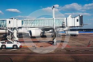 Airplane in the airport near jet bridge