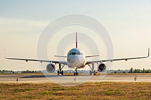 Airplane on airport runway, front view. Travel and transportation concept