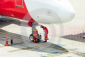 Airplane in airport serviced by the ground crew photo