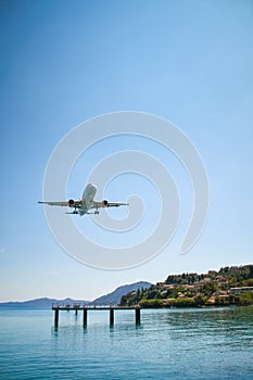 an airplane approaching Corfu town, close to the sea