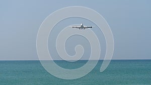 Airplane approaching over ocean