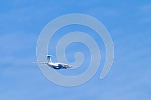 Airplane in blue sky. Air cargo transportation. Plane is flying