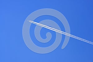 Airplane in blue sky background and white trace