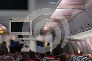 Airplane cabin full of passengers during a flight