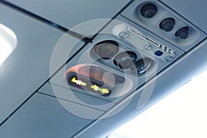 Airplane cabin interior detail. No smoking and seat belt signal