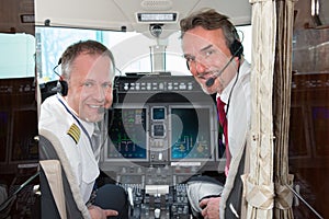 Airplane cockpit pilot crew smiling at camera