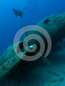 Diver exploring wreck of aircraft