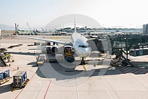 Airplane docking at airport terminal gate, loading luggage prepare to departure. Plane transit, take off operation