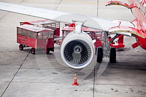 Airplane engine in front of loading luggage from airplane