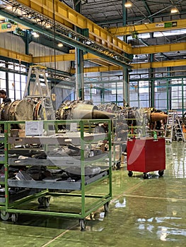 Airplane Engine Maintenance Technicians Repairing Aircraft Jet Engine in a Modern Workshop