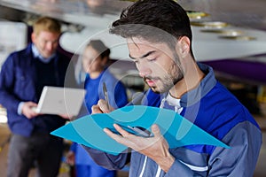 airplane engineer taking notes on notepad