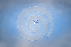 An airplane fading dissolve on sky and white cloud, looking up