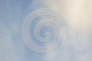 An airplane fading dissolve on sky and white cloud, looking up