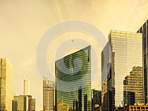 An airplane flies above modern architecture along Wacker Drive at Wolf Point in Chicago. Urban cityscape. photo