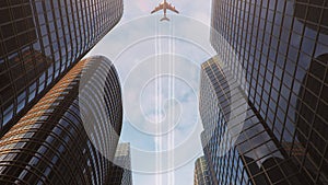 Airplane flight over the business center of skyscrapers. Bottom view of skyscrapers with a flying plane at sunset in the