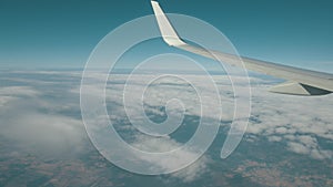 Airplane flight. View through the window of an airplane of the wing and turbine.