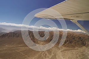 An airplane is fly on the area of Nazca Lines, and is going to take tourists over the Nazca Lines.