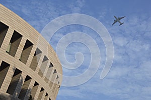 Airplane fly over the Modern building.