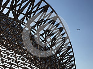 Airplane fly by a steel sculpture