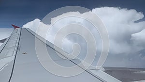 Airplane Flying Above Clouds In Blue Sky. Beautiful View From Window Of Aircraft.