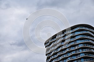 Airplane flying above a large building in London