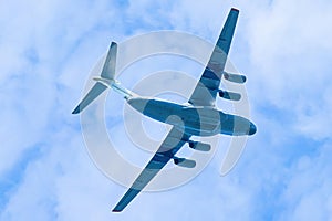 Airplane is flying in blue sky. Commercial passenger and cargo a