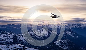 Airplane flying near the Beautiful Canadian Mountain Nature Landscape