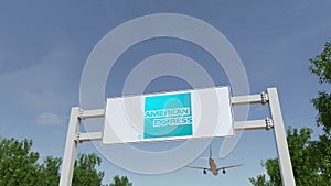 Airplane flying over advertising billboard with American Express logo. Editorial 3D rendering