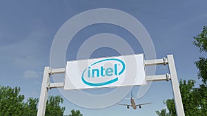 Airplane flying over advertising billboard with Intel Corporation logo. Editorial 3D rendering