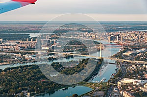 Airplane flying over Belgrade cityscape in Serbia