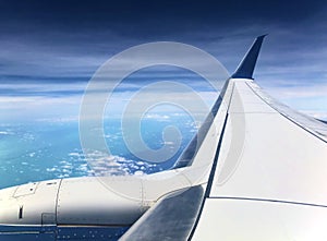 Airplane flying over Bright Blue Atlantic Ocean