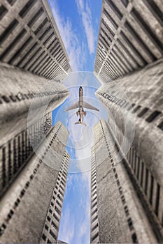 Airplane flying over business skyscrapers in Malaysia.