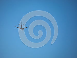 Airplane flying over a completely clear blue sky
