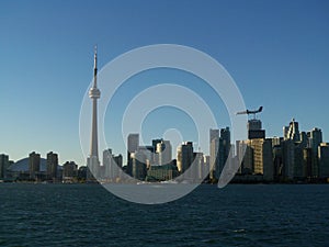 Airplane flying over Downtown Toronto Ontario Canada skyline view from Lake Ontario