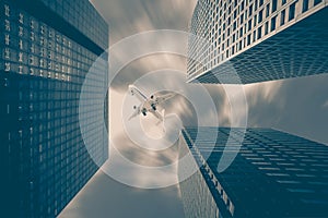 Airplane flying over high rise building