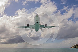 Airplane flying over Maho Beach, Sint Maarten, Dutch Caribbean photo