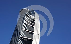 Airplane is flying over the modern building